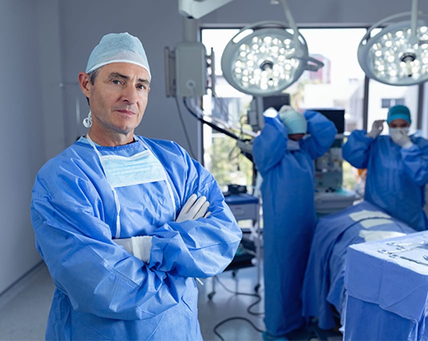 Male-surgeon-standing-with-arms-crossed-while-surgical-team-prepares-for-a-SpaceOar-operation